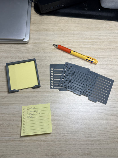 A collection of sticky notes, a pen, and a biodegradable plastic holder with stencils, displayed on a wooden desk.