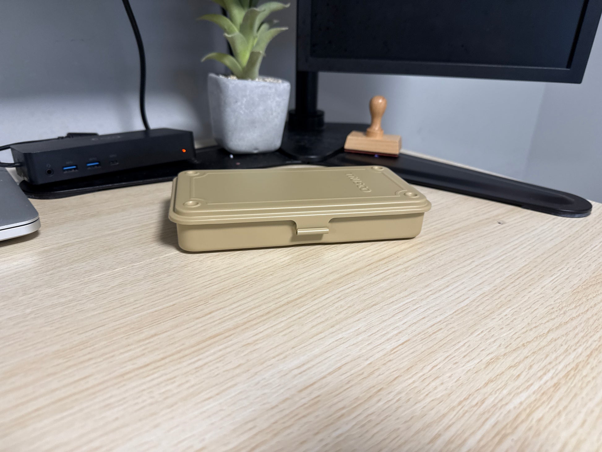 Trusco T-19 stackable metal toolbox shown closed against a clean wooden desk