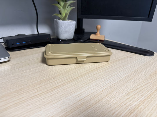 Trusco T-19 stackable metal toolbox shown closed against a clean wooden desk