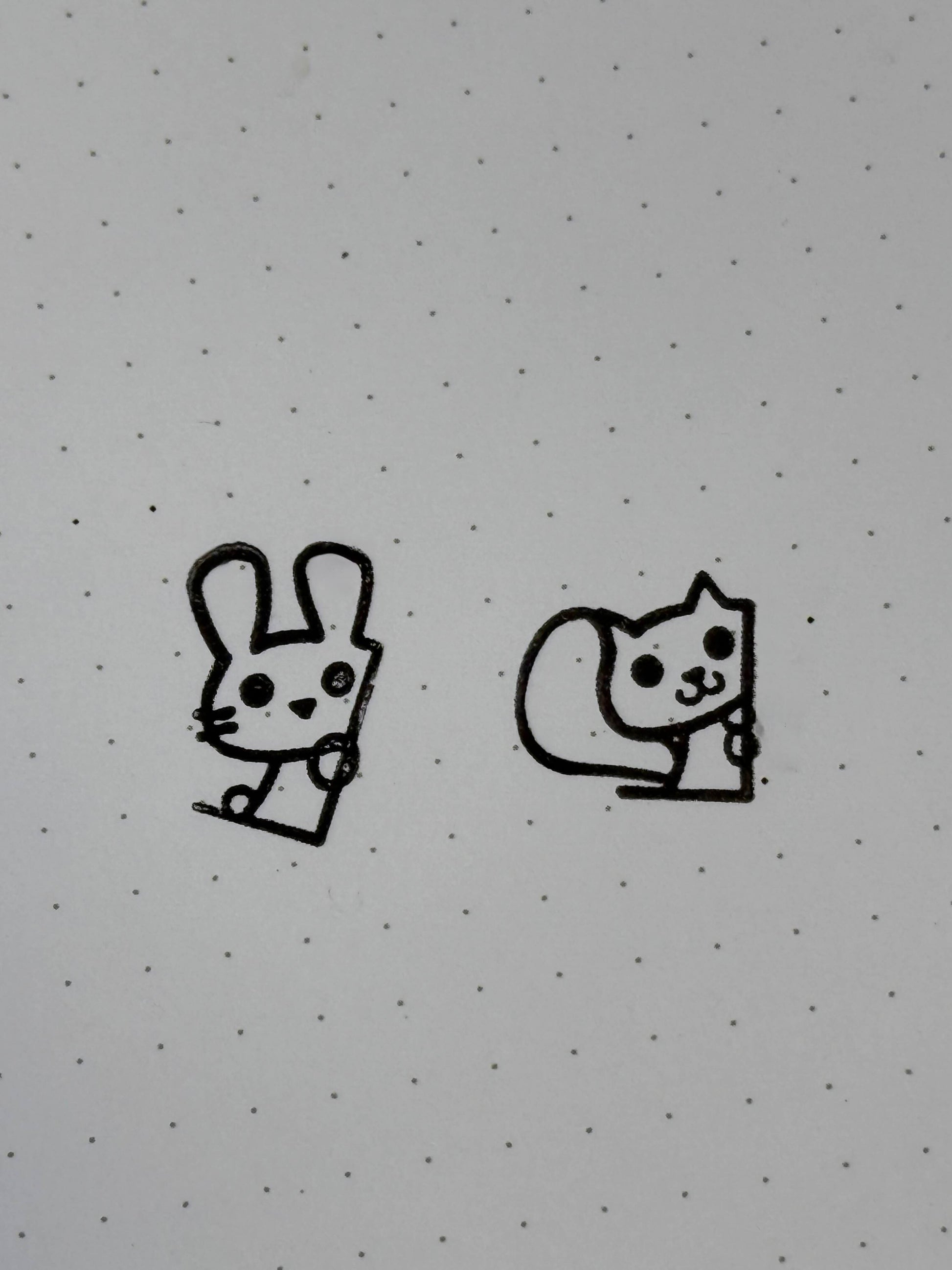 A stamp of a bunny and of a squirrel on dot paper.