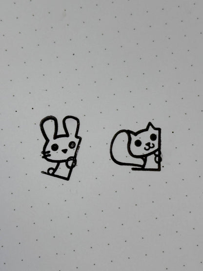 A stamp of a bunny and of a squirrel on dot paper.
